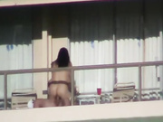 Amateur voyeur couple fucking on balcony in public